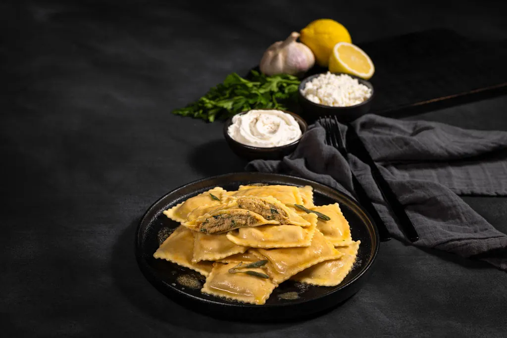 Lobster ravioli plated with lemon, chives and mascarpone